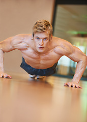 Image showing Man, exercise and pushup on floor, fitness and workout for muscle development, growth and results for health. Person, gym and bodybuilder with training process, strong arms and progress for wellness