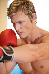 Image showing Man, fitness and boxing with punching in gym for vision, power or exercise for fight, wellness or health. Contact sports training, athlete and person in gloves, action or martial arts workout in club