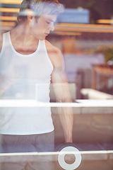 Image showing Man, dumbbells and workout by gym window with vision, thinking and strong arms for muscle development. Bodybuilder person, fitness and training for body transformation, health and wellness at club