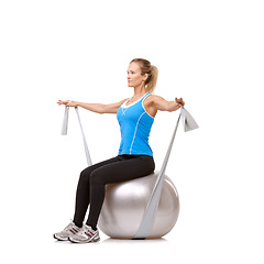 Image showing Exercise ball, resistance band and woman doing workout in studio for health, wellness and body care. Sports, fitness and female person from Canada stretching arms or training by white background