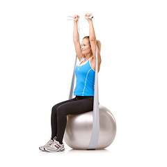 Image showing Yoga ball, resistance band and woman doing exercise in studio for health, wellness and body care. Sports, fitness and young female person from Canada with arms workout or training by white background