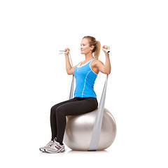 Image showing Yoga ball, resistance band and woman doing workout in studio for health, wellness and body care. Sports, fitness and young female person from Canada with arms exercise or training by white background