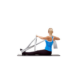 Image showing Wellness, resistance band and woman doing exercise in studio for health, fitness and bodycare. Sport, yoga mat and young female person from Australia with arms workout or training by white background