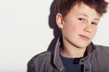 Image showing Teenager, portrait and boy with fashion in studio, white background with a smirk or smile. Cool, style and child with confidence in trendy clothes, outfit and pride in personality on backdrop