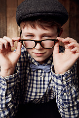 Image showing Young child, portrait and glasses with thinking in mockup, pensive and vintage fashion with eyesight. Boy, face or geek in thought in retro clothes with eyewear, contemplation or smart kid for vision