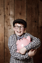 Image showing Piggy bank, hug and portrait of boy child with savings, growth or investment success in his home. Finance, learning and face of excited kid with money box for future education, funding or security