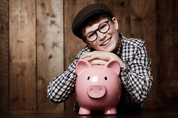 Image showing Piggy bank, portrait and boy child smile with savings, growth or investment success in his home. Finance, learning and face of excited kid with money box for future education, funding or security
