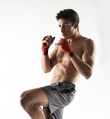 Image showing Man, kick boxer and strong in gym, serious and face for workout, boxing or white background. Exercise, sports and training for power, self defense and concentrate for challenge, mma or fight skills