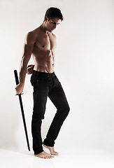 Image showing Man, katana or sword with muscle, studio and thinking with vision for conflict, martial arts or fight by white background. Person, ninja or assassin with weapon, steel blade or idea for battle in war