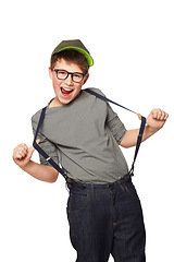 Image showing Portrait, smile or kids fashion and a boy nerd in studio isolated on a white background with suspenders. Funny, glasses and geek with a happy young or trendy child looking excited in a clothes outfit