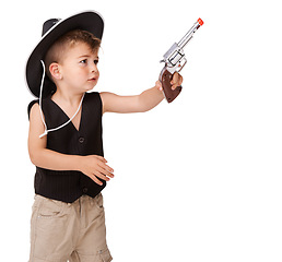 Image showing Kid, cowboy hat and toy gun in studio isolated on a white background mockup space. Child, pistol and play in western costume for halloween, shooting and cute young boy dress up on holiday for fun