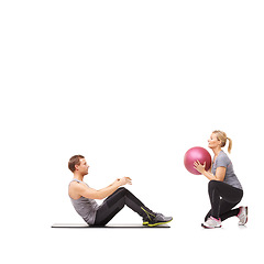 Image showing Coaching, man and woman with gym ball for pilates in studio, body fitness and support. Sports workout, fit girl and personal trainer with sphere for balance, training and power on white background.