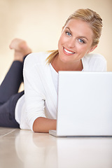 Image showing Portrait, woman and remote work with laptop on floor to update blog post, social media and digital subscription at home. Happy freelancer relax with computer for online shopping, elearning and email