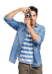 Image showing Photography, portrait and man with a camera in a studio for creative or art career with confidence. Casual, vintage dslr equipment and young male photographer from Canada isolated by white background