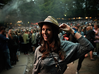 Image showing Excited woman, portrait and night at music festival party, event or outdoor DJ concert. Happy female person smile with hat in evening crowd or audience at carnival, performance or summer fest outside