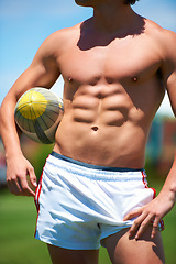 Image showing Topless, man and rugby player holding a ball closeup for training or sports practice on a field. Body, male athlete person and playing active competitive game for health and strength outdoors