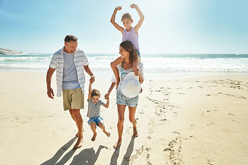 Image showing Parents, children and swing on beach holiday for travel sunshine, ocean piggy back or sibling development. Man, woman and kid playful on sand for vacation walk or outdoor, sea relax or love nature