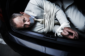 Image showing Car boot, crime and portrait of business man with tape, rope and kidnap danger in parking lot. Fear, stress and face of male victim in a vehicle trunk with anxiety, horror or panic, scared or ransom