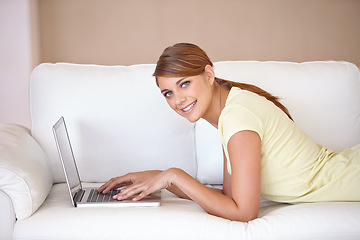 Image showing Woman, portrait and typing on laptop at sofa to update blog post, social media or digital subscription for remote work. Happy freelancer on computer for online shopping, email or relax in living room