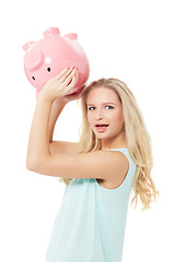 Image showing Woman, piggy bank and finance or surprised in studio with cash investment, financial growth or wealth. Person, money box and budget or banking for increase or income on white background with smile