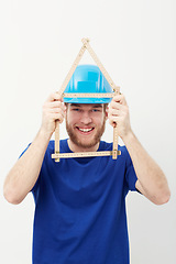 Image showing Carpenter man, ruler and studio portrait with smile, security and helmet for construction by white background. Person, handyman or architect with measuring, maintenance and building in wood industry