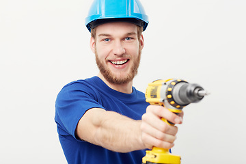 Image showing Construction man, portrait and power drill in hand, studio and maintenance by white background. Person, employee or small business owner with tools, helmet or happy for job at repair services company