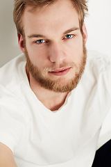 Image showing Man, portrait and confident or fashion in studio with casual style, trendy outfit and calm expression. Person, face and relaxing, tshirt and satisfaction with peace and pride on white background