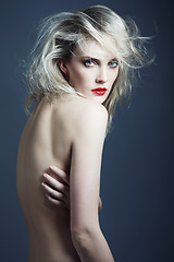 Image showing Portrait, beauty and body of nude woman in studio isolated on a blue background mockup space. Face, makeup cosmetics and confident naked female model, sexy skin and serious blonde person in lipstick