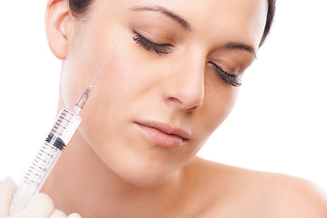 Image showing Woman, face and needle for plastic surgery in studio for injection, chemical or product by white background. Girl patient, person and syringe for change, transformation or results for facial beauty