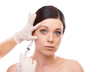 Image showing Woman, portrait and syringe for plastic surgery in studio for injection, chemical and product by white background. Girl patient, surgeon and needle for change, transformation and results with beauty