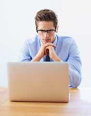 Image showing Business man, confused and thinking on computer for research, online planning and investment decision. Professional analyst or trader in reading glasses, problem solving or trading solution on laptop