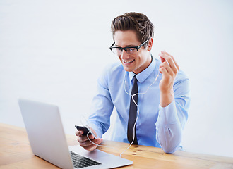 Image showing Headphones, business and man with a smartphone, laptop and listening to music in a workplace. Person, employee and consultant with a cellphone, sound and streaming audio with radio, podcast and smile