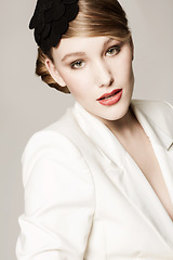 Image showing Woman, portrait and vintage fashion in studio with confidence, pride and elegant style with hairband. Person, face and designer outfit with hair accessory or classic for aesthetic on white background