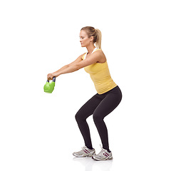 Image showing Training, fitness and studio woman with kettlebell swing for muscle growth, arm power development or weightlifting. Sports club equipment, wellness activity and female bodybuilder on white background