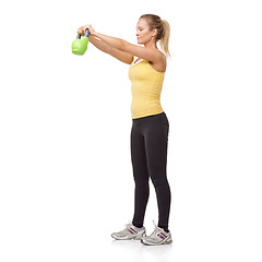 Image showing Exercise, workout and studio woman with kettlebell swing for muscle growth, strong arm strength or weightlifting. Fitness club equipment, wellness commitment and girl bodybuilding on white background