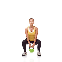 Image showing Fitness, portrait and woman exercise with kettlebell swing, squat or workout for muscle growth, arm strength or bodybuilding. Studio, weightlifting hard work and athlete training on white background