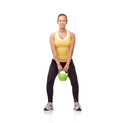 Image showing Training, portrait and studio woman with kettlebell for muscle growth, strength development or weightlifting performance. Gym equipment, bodybuilding routine and athlete isolated on white background