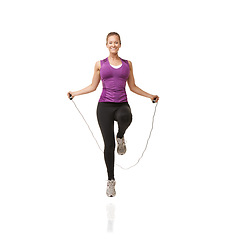 Image showing Fitness, skipping rope and portrait of woman on a white background for exercise, cardio workout and training. Sports, studio and isolated person with gym equipment for health, wellness and jumping