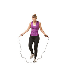 Image showing Fitness, skipping rope and woman on a white background for training, cardio workout and exercise. Sports, endurance and isolated person with gym equipment for health, wellness and jumping in studio