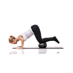Image showing Balance, exercise and woman on floor with ball for pilates, body building care and health in studio. Gym, training and girl on mat with cardio, energy and muscle workout isolated on white background.