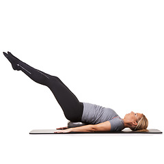 Image showing Exercise legs, pilates and woman on ball in workout, training and healthy body isolated on a white studio background mockup space. Floor, mat and person on equipment for sports, balance or fitness