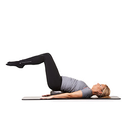 Image showing Exercise legs, pilates and woman on ball in workout, training and healthy body isolated on a white studio background mockup space. Floor, mat and person on equipment for sports, balance or fitness