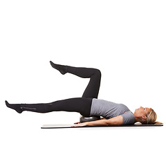 Image showing Training legs, pilates and woman on ball in workout, exercise and healthy body isolated on a white studio background mockup space. Core, mat and person on equipment for sports, balance or fitness