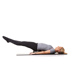Image showing Woman, exercise ball and legs balance on yoga mat for workout performance, wellness or white background. Female person, gym equipment and fitness in studio for mockup space, challenge or stretching