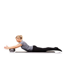 Image showing Woman, exercise ball and stretching on yoga mat or workout performance, pilates wellness or white background. Female person, gym equipment and fitness in studio for mockup space, challenge or balance