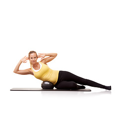 Image showing Woman, portrait and crunch with exercise ball on side for abductor workout, mockup space or white background. Female person, face and equipment in studio for training, balance or abdomen wellness