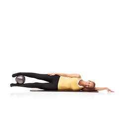 Image showing Woman, portrait and ball or legs balance on side for squeeze abductor, strong thighs or white background. Female person, face and equipment in studio for health training, gym muscle or mockup space