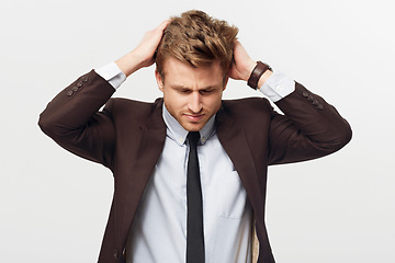 Image showing Stress, burnout and mistake with a business man in studio isolated on a white background for error. Anxiety, fail and frustration with a young employee looking worried in a suit for corporate work