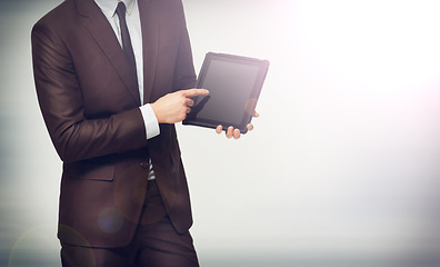 Image showing Hand, tablet and pointing with a business man on space in studio for advertising or digital marketing. Tech, mockup or presentation and a professional employee with corporate information on screen