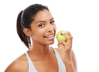 Image showing Happy woman, apple and eating of healthy food for nutrition, detox and wellness in a studio portrait. Young african person with green fruit for healthcare, lunch or vegan choice on a white background